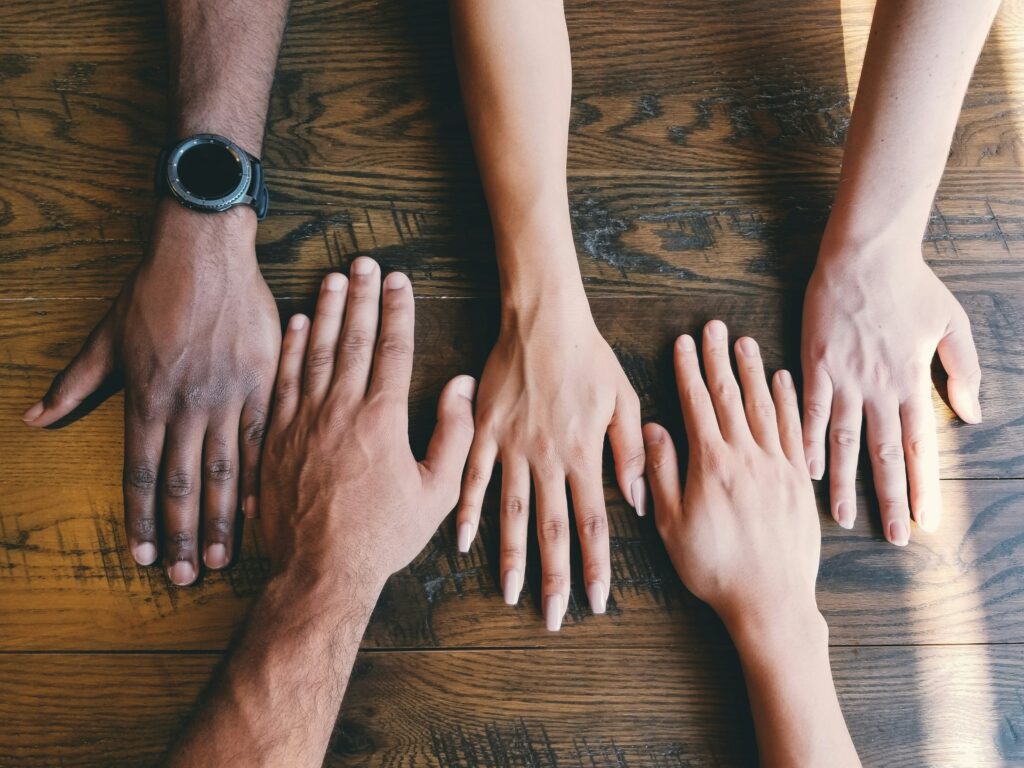 Five human Hands by Clay Banks from Unsplash https://unsplash.com/photos/five-human-hands-on-brown-surface-LjqARJaJotc?utm_content=creditCopyText&utm_medium=referral&utm_source=unsplash